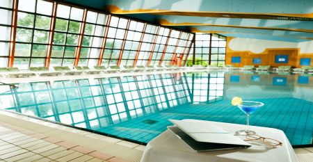 Ein moderner Außenpool mit klaren Bahnen, perfekt für Trainingseinheiten, mit umliegenden Sonnenschirmen.